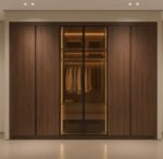 دولاب دريسنج روم خشب بني غامق وأبواب زجاجية مضيئة من تصميم ادم فرنتشر (ADM Furniture)، حلول تخزين داخلية وإضاءة LED مدمجة